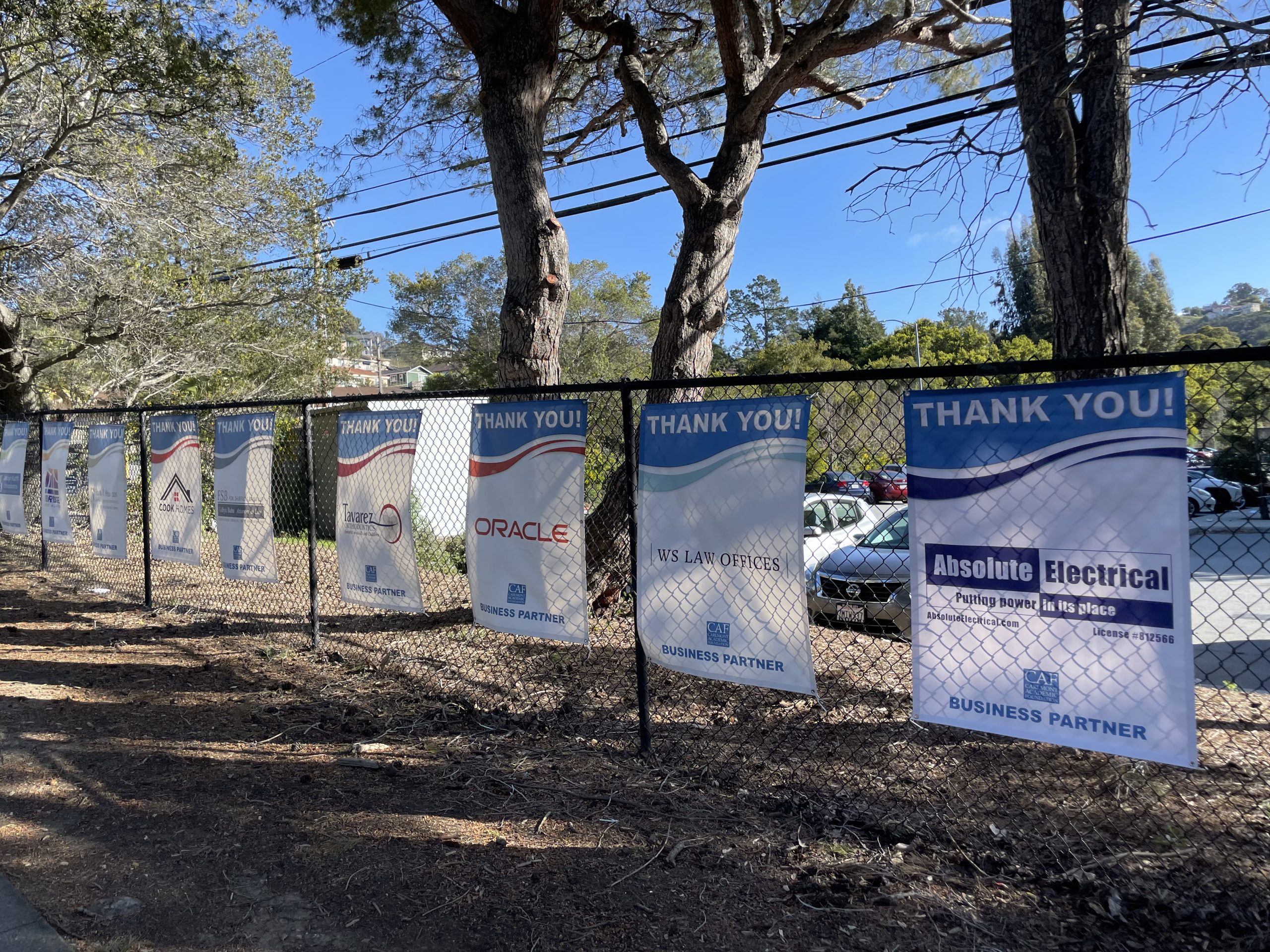 Business sponsor banners in front of Carlmont High School